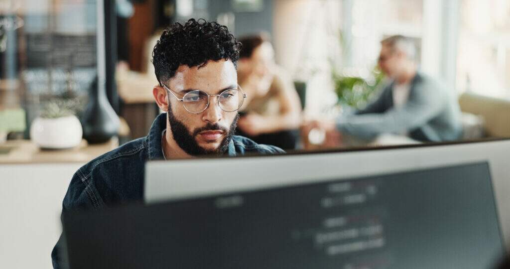 Mudar de carreira para tecnologia: jovem desenvolvedor no trabalho