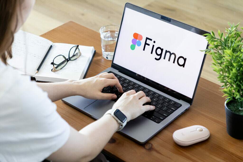 O que é Figma: jovem desenha o layout de um aplicativo em papel antes de passar para a ferramenta